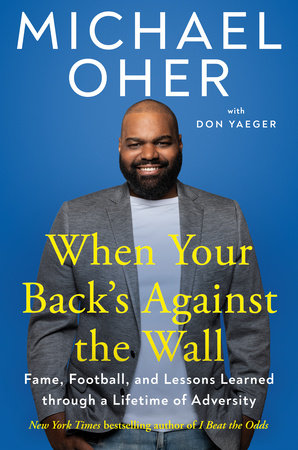 Michael Oher signs When Your Back's Against the Wall